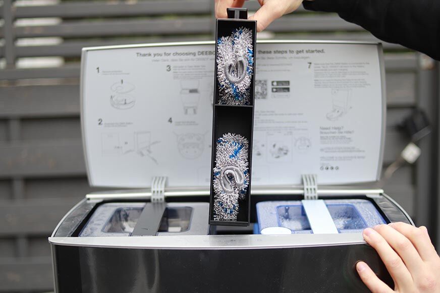 The organisation of the upper compartment of the Ecovacs Deebot Station can be seen.